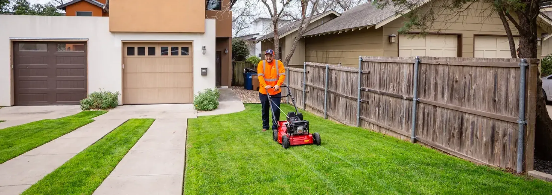 Tech mowing lawn