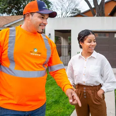 Lawn technician speaking with customer